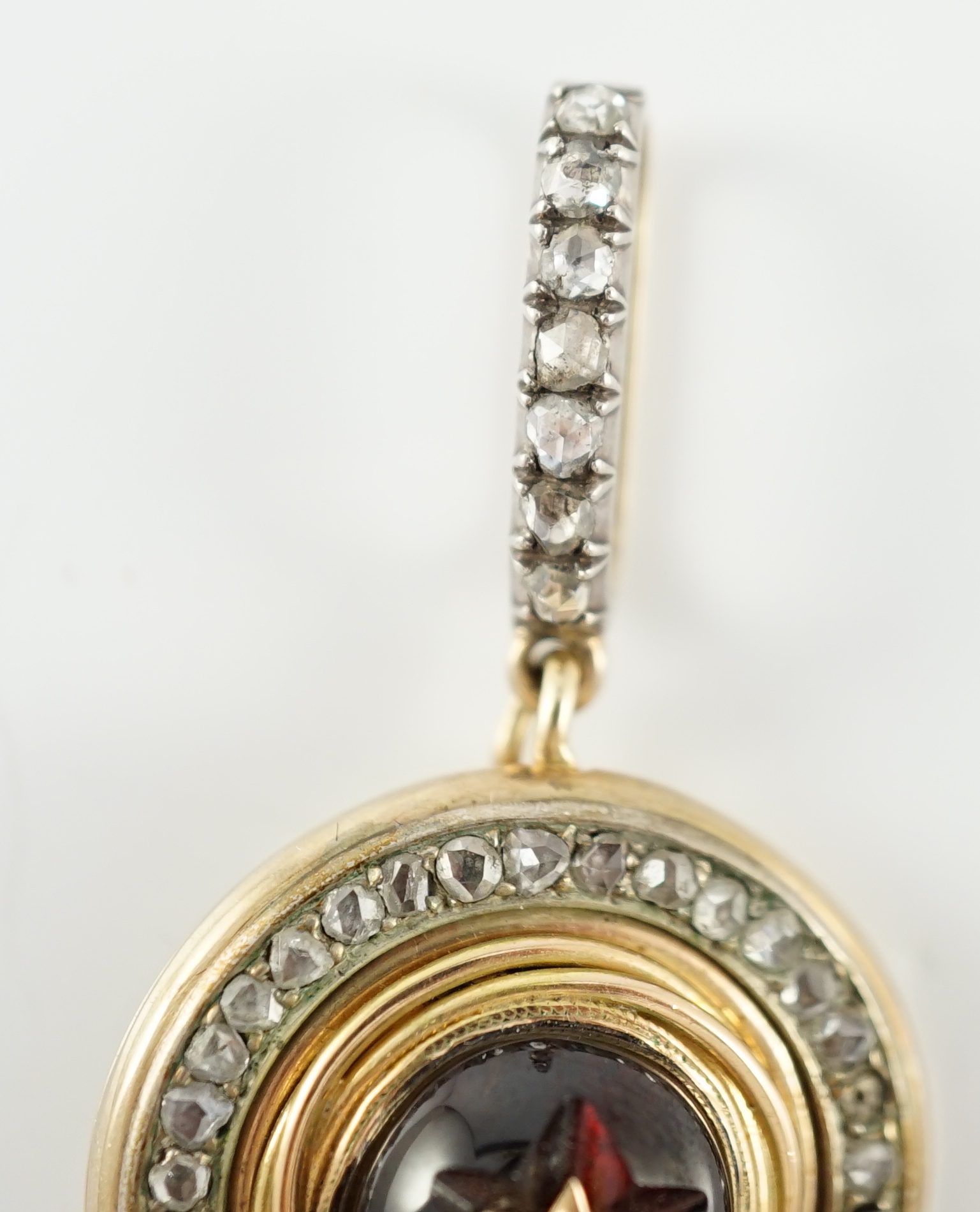 A 19th century gold, cabochon garnet and rose cut diamond set cluster target pendant